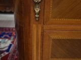 a wooden cabinet with a marble top in a room