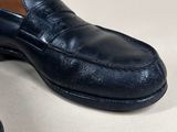 pair of men ' s black leather loafers on a white surface