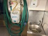 an image of a kitchen with a sink and a hose