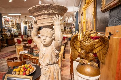 a statue of a woman holding a basket on her head