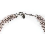 a close up of a necklace on a white background
