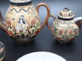 many different types of teapots on the table