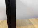 a close up of a black computer on a wooden table