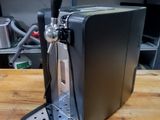 a beer dispenser sitting on a table in a kitchen