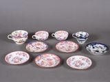 several different types of porcelain dishes and cups on a gray surface