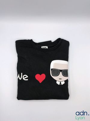 a black t - shirt with a picture of a man wearing sunglasses and a red heart