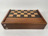 a wooden chess board with black and white squares on it