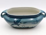 a blue and white bowl with a bird design on it