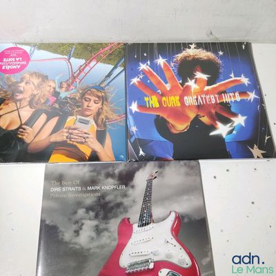 two cds on the table with a guitar in front of them