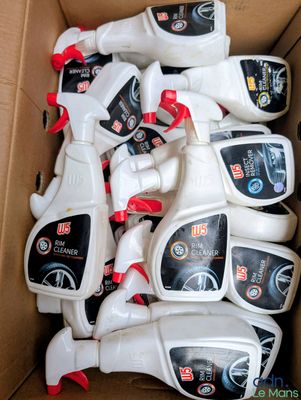 a box full of sprays and bottles of cleaner