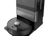 a robotic vacuum cleaner is on top of a black box