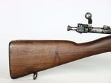 an old rifle with a wooden barrel on a white background