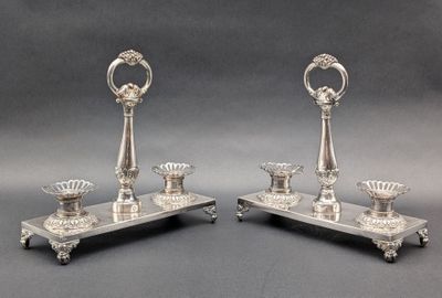pair of silver plated candlesticks on stand