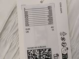 the back of a white shirt with a qr code attached to it