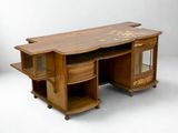 a wooden desk with a glass cabinet on top of it