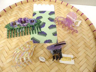 a basket with a bunch of hair accessories on it