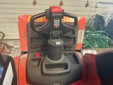 a red forklift with a black handle and a red seat