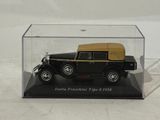a black and gold model of a car in a glass case