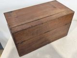 an old wooden box sitting on top of a white table