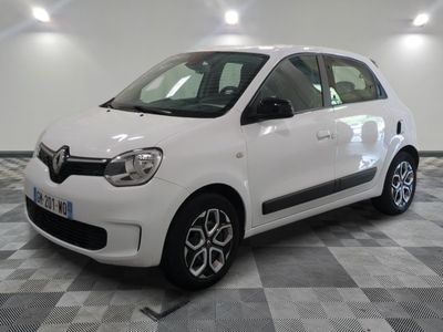 a picture of a small white car parked on a checkered floor
