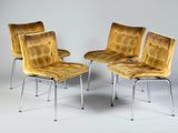 three yellow chairs sitting next to each other on a white surface