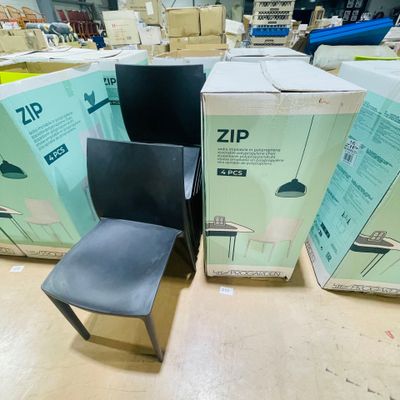 a black chair sitting next to a box of boxes on the floor