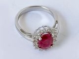 an image of a ruby and diamond ring on a white surface