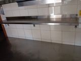 a stainless steel shelf in the middle of a kitchen