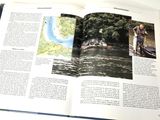 an open book with a picture of a man on a boat