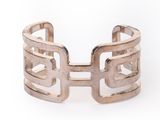 a close up of a silver cuff bracelet on a white background
