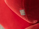 a close up of a red couch with a label on it