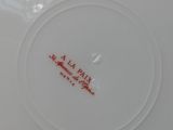 an image of a white plate with a red design on it