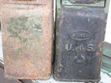 two old rusted metal boxes sitting on a table