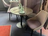 three chairs and a table in the corner of a room
