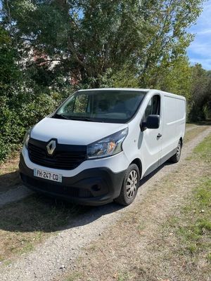 the white van is parked on the side of the road