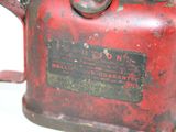an old red gas can that is sitting on a table