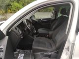 the interior of a car with the door open and the driver ' s seat down