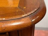 a close up of a wooden table with peeling paint on it