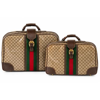 a pair of luggage bags with a green and red stripe