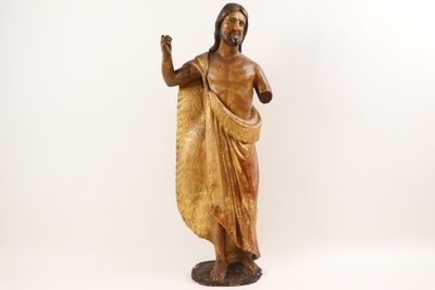 wooden statue of jesus with raised hand on a white background