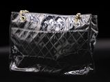 a close up of a black purse on a black background