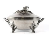 a silver plate with a bird on top of it
