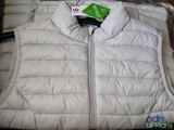 a white vest with a green tag on it