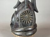 an image of a silver vase with a bird on top of it