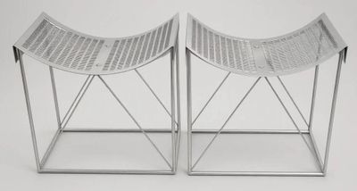 pair of white wicker stools with metal legs on a white background