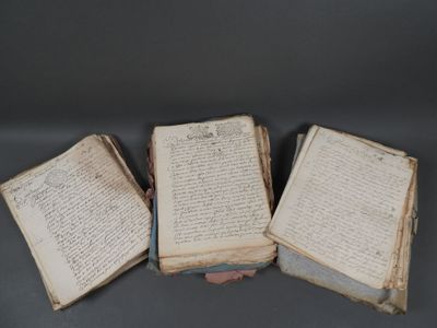 three open books sitting on top of each other on top of a table