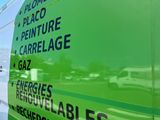 a green van that is parked on the side of the road