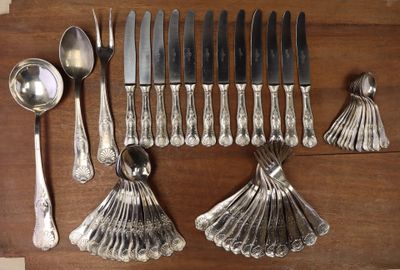 a lot of silverware on a table with spoons and spoons