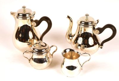 three pieces of silver tea and coffee set on a white background