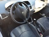 dashboard of a small car with black leather seats and a steering wheel